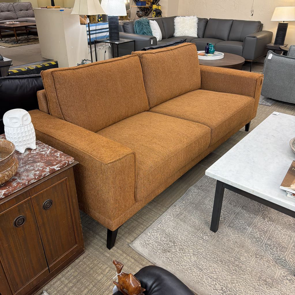 Brown sofa in a room with other furniture and decor