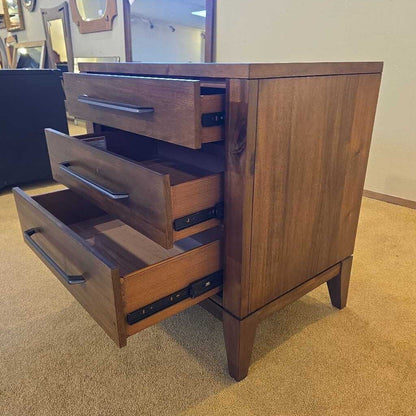 Wooden dresser with open drawers in a room setting