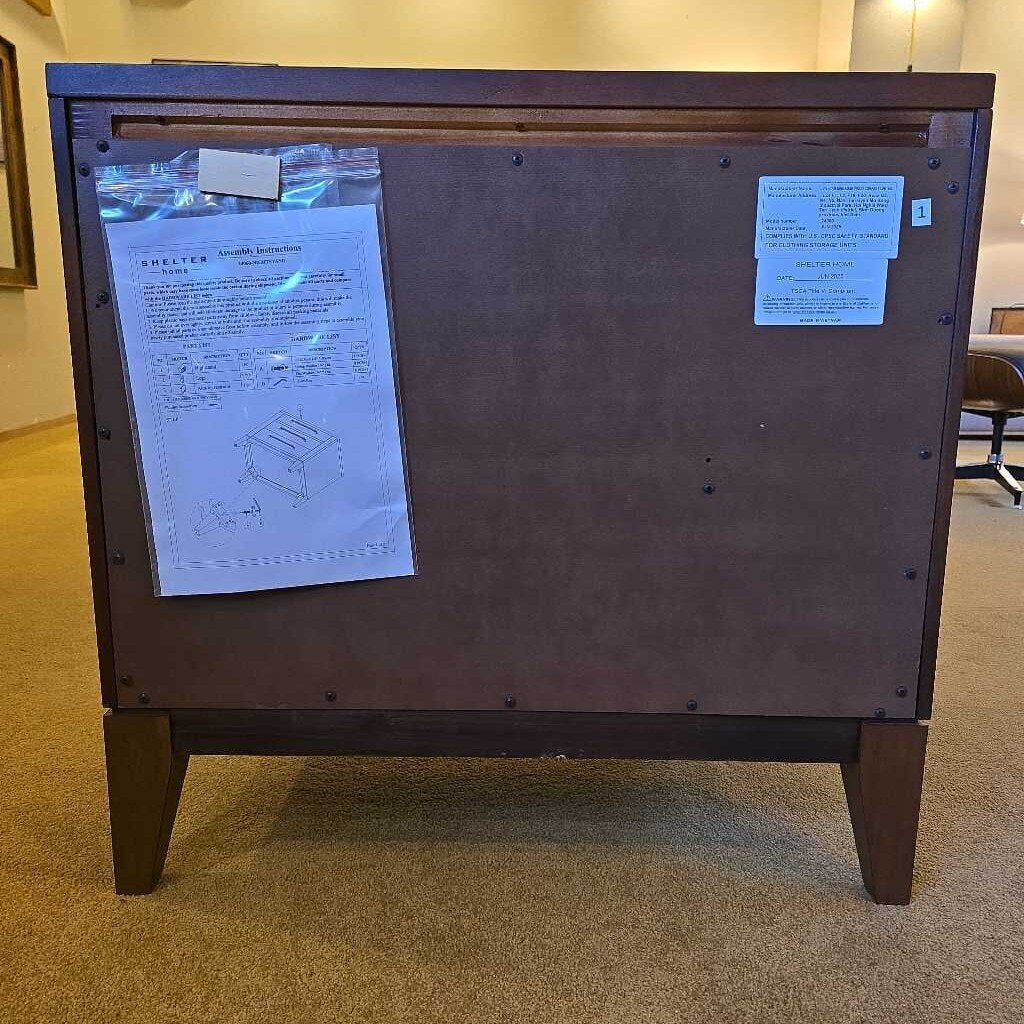 Wooden cabinet with blueprints attached on a carpeted floor