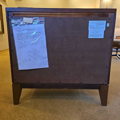 Wooden cabinet with blueprints attached on a carpeted floor