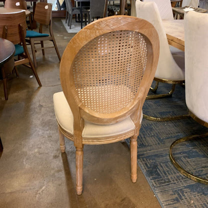 Wooden chair with a wicker backrest in a furniture store setting