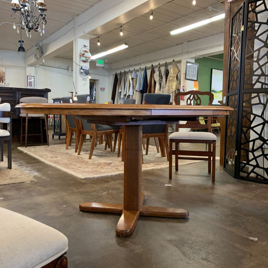 Wooden dining table with chairs in a showroom setting