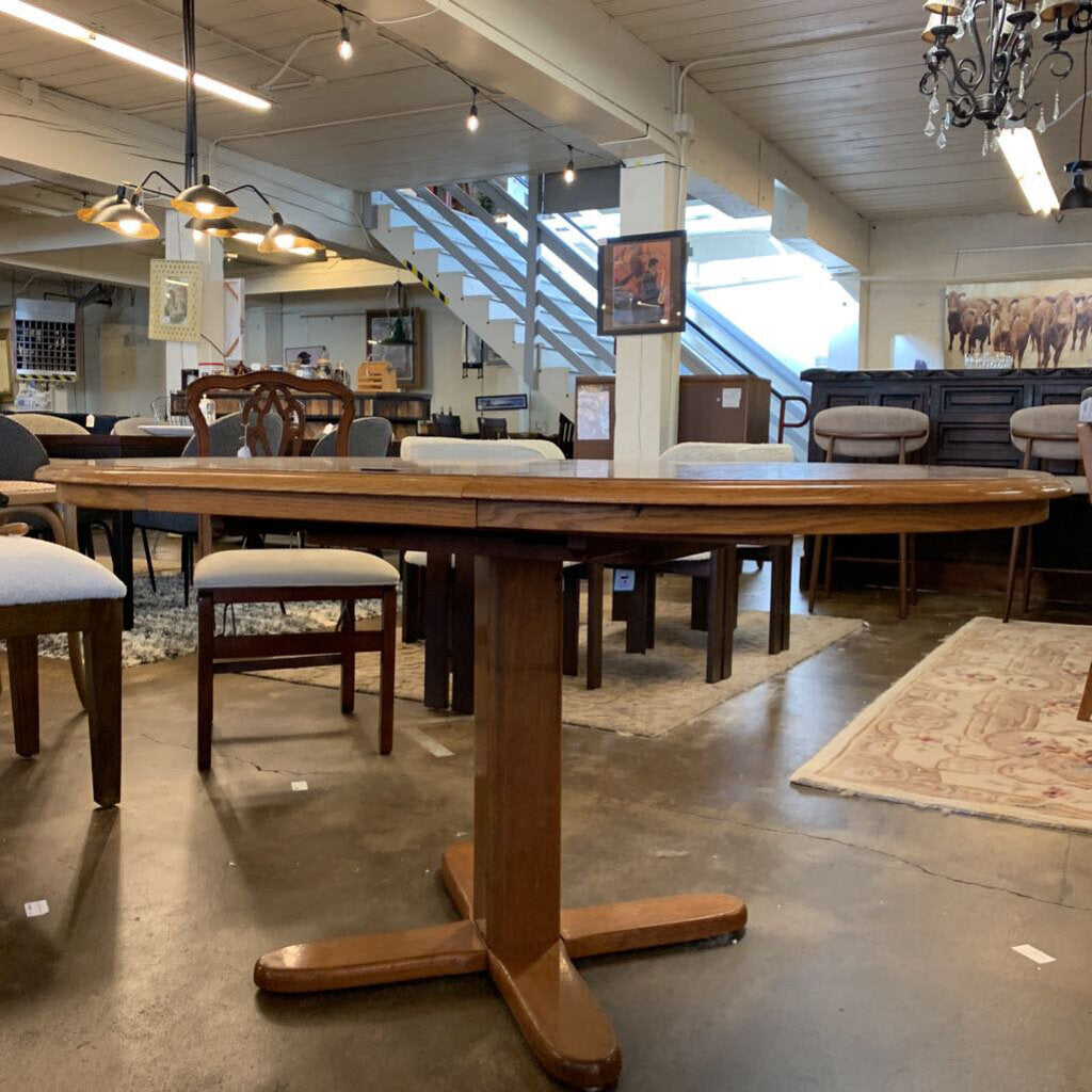 Wooden dining table with chairs in a furniture store setting