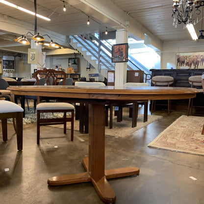 Wooden dining table with chairs in a furniture store setting