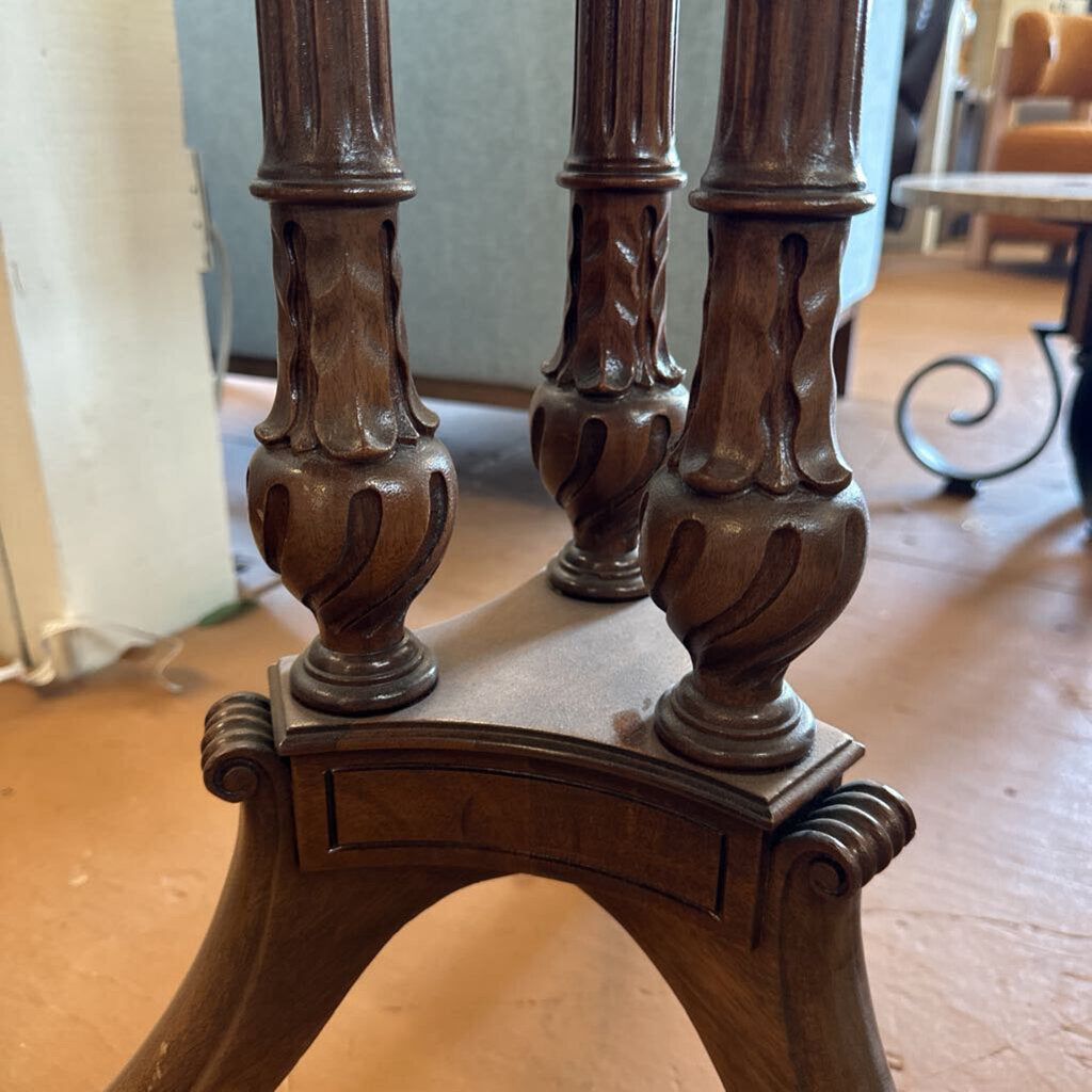 Close-up of ornate wooden chair legs with a blurred indoor background