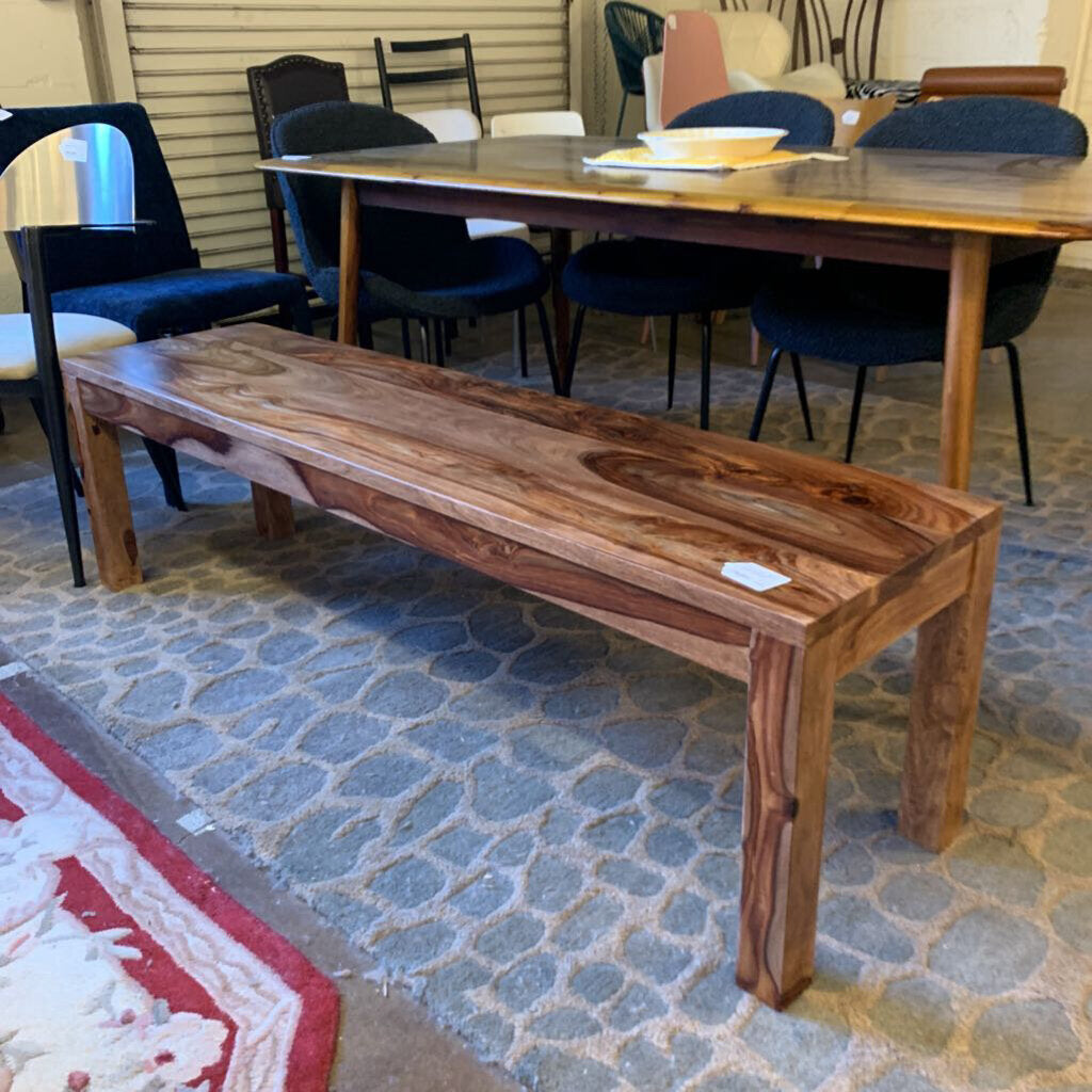 Wooden bench in a room with chairs and a table
