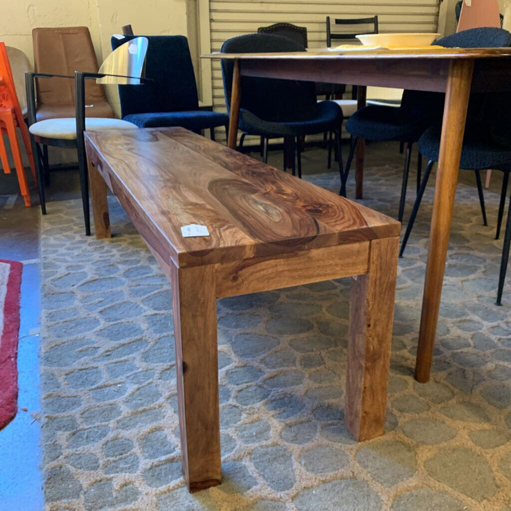Wooden bench in a room with chairs and tables