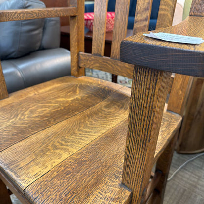 Close-up of a wooden chair with a blurred background