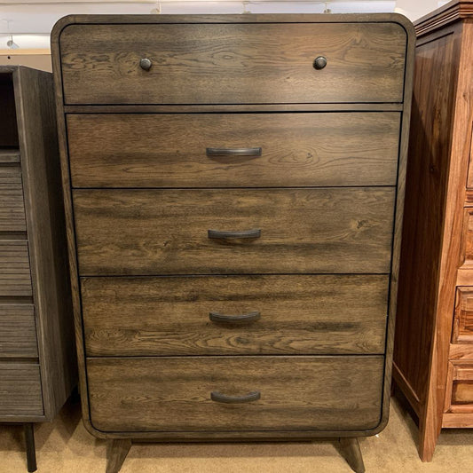 Wooden dresser with four drawers in a showroom setting