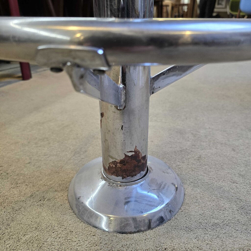 Close-up of a metal chair leg with rust and wear
