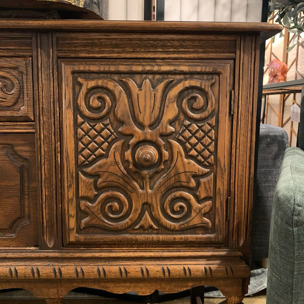 Wooden cabinet with intricate carvings in a home setting