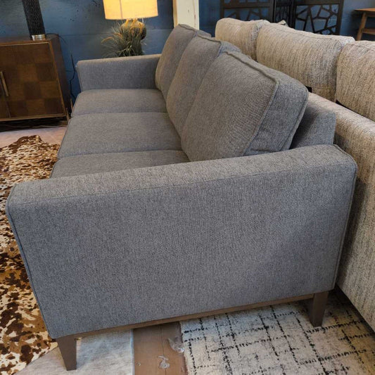 Gray sofa with cushions in a living room setting