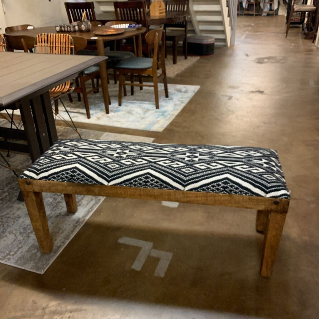 Wooden bench with a patterned cushion in a casual dining setting