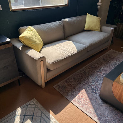 Gray sofa with yellow cushions in a living room setting