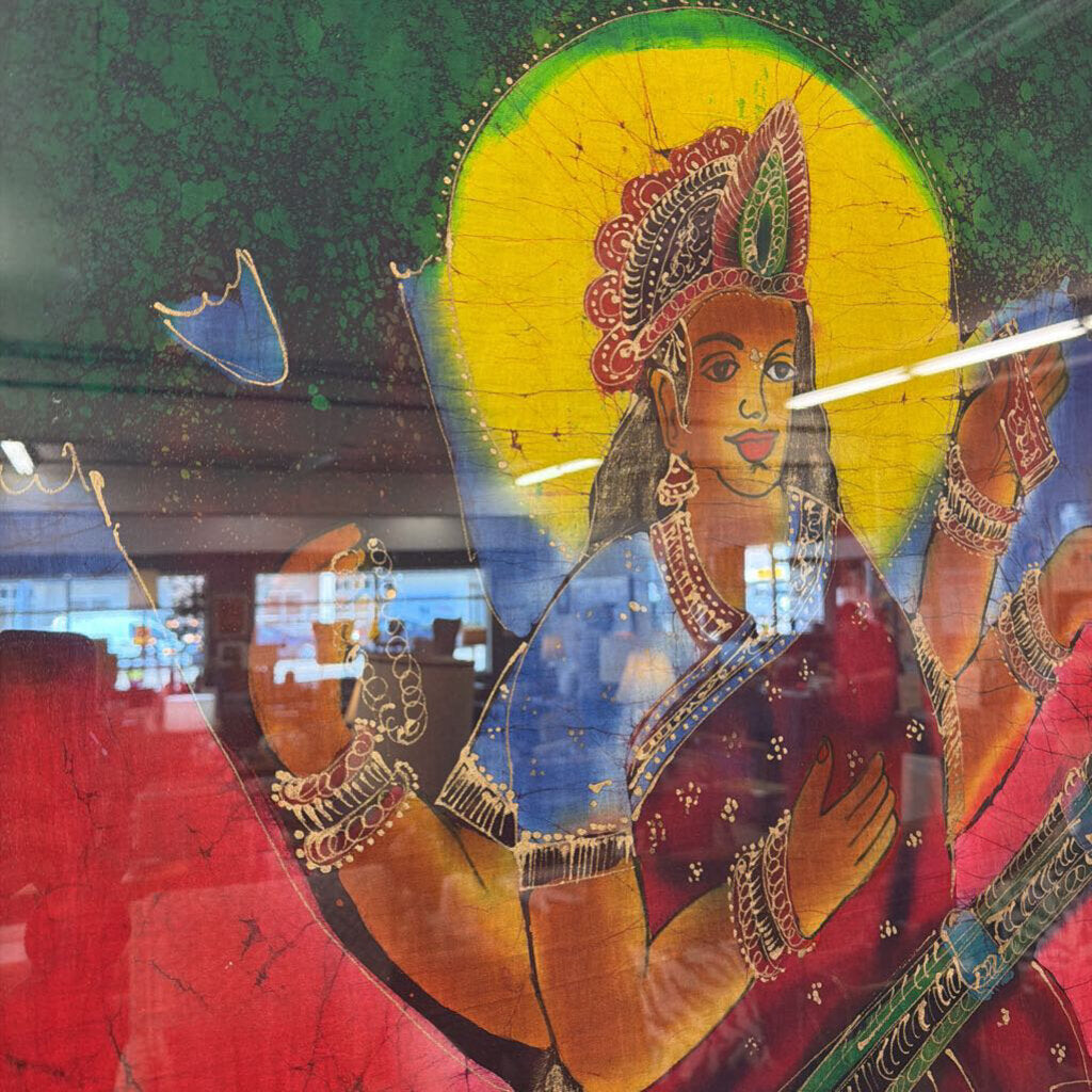 Colorful depiction of a deity with intricate jewelry and attire, likely from a religious or cultural artwork.