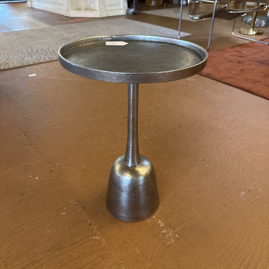 Small metal side table on a wooden floor