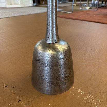 Metal bell on a wooden surface