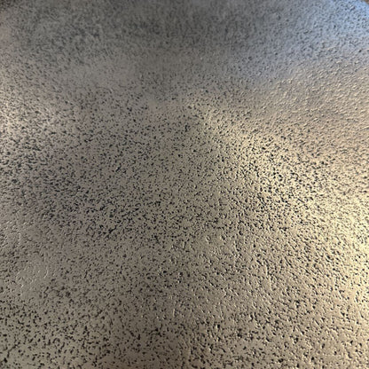 Textured gray surface with a light source creating a gradient effect