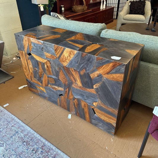 Wooden side table with a geometric pattern in a living room setting
