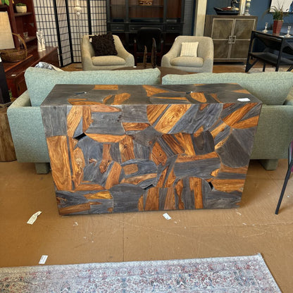 Wooden coffee table with a geometric pattern in a room with furniture and decor.