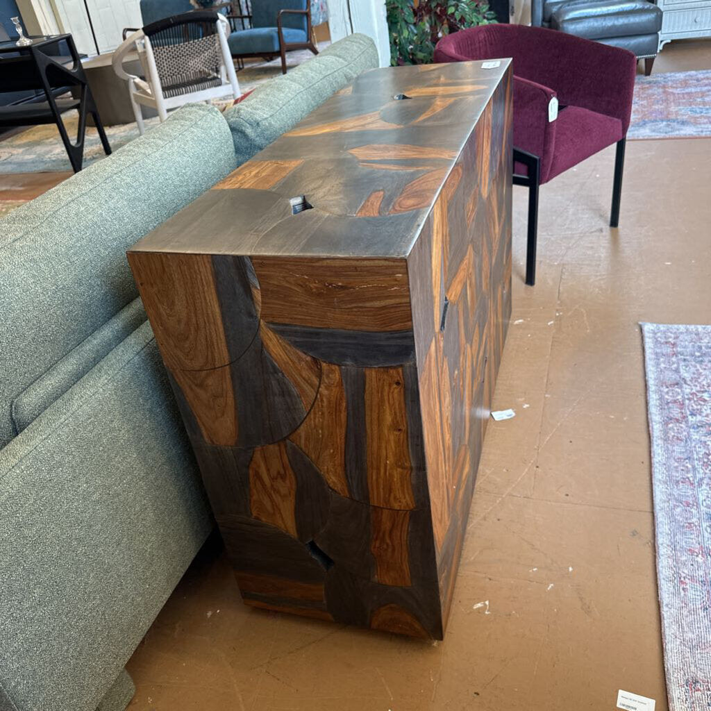 Wooden console table in a living room setting with furniture and decor.