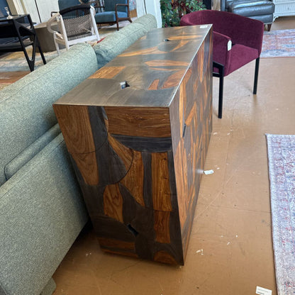 Wooden console table in a living room setting with furniture and decor.