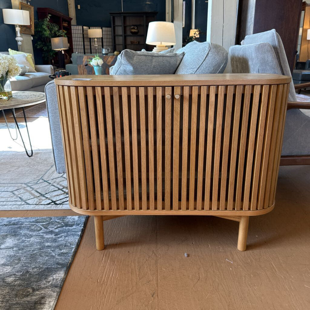 Wooden sideboard in a living room setting with a sofa and coffee table.
