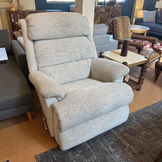 Gray recliner chair in a living room setting with furniture and decor.