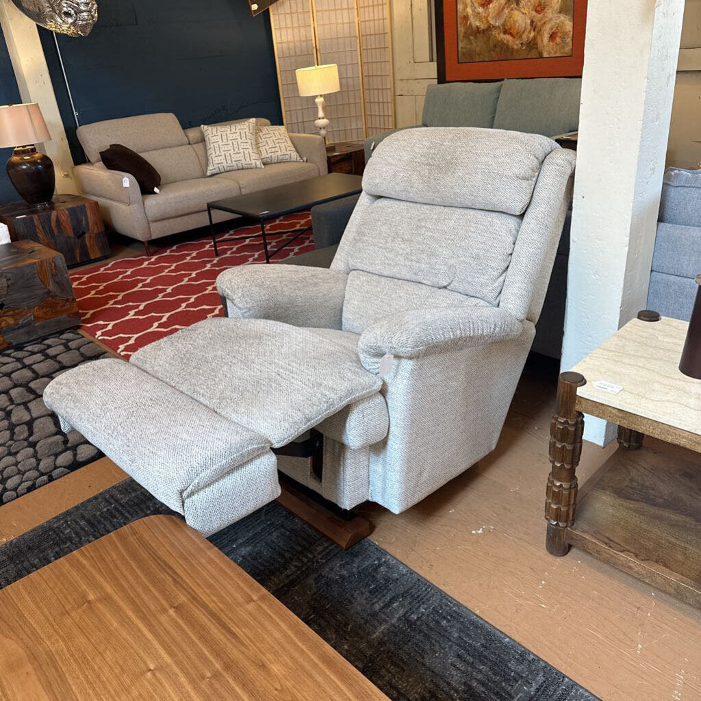 Gray recliner chair in a living room setting with furniture and decor.