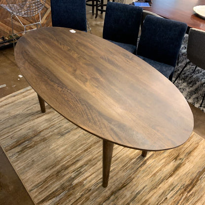 Wooden dining table with chairs in a room setting