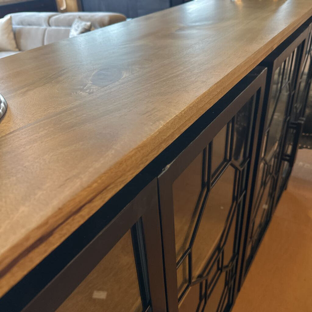 Wooden surface with a decorative metal frame in the background