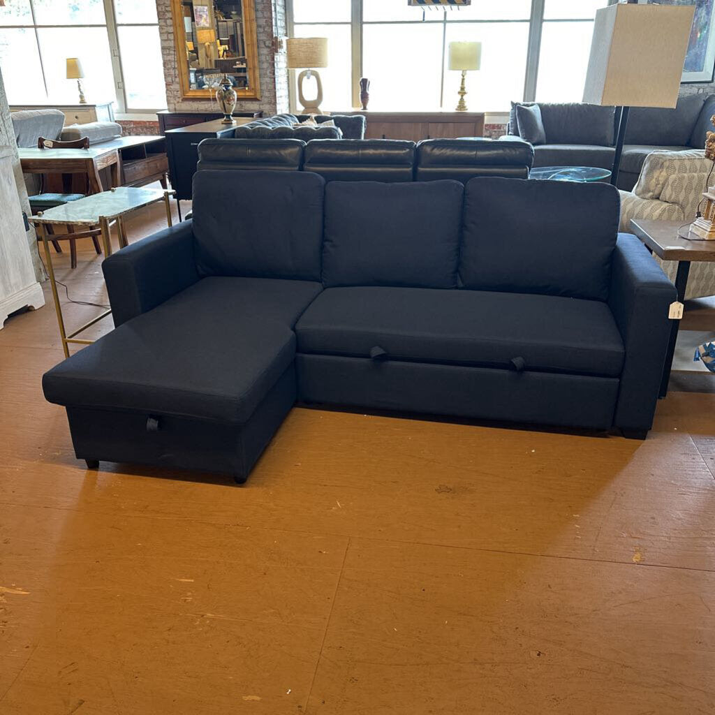 Blue sectional sofa in a showroom setting with wooden flooring.