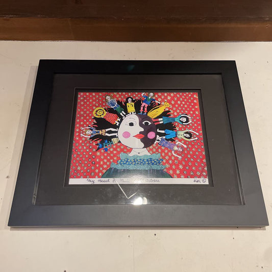 Framed artwork with a colorful character on a red background