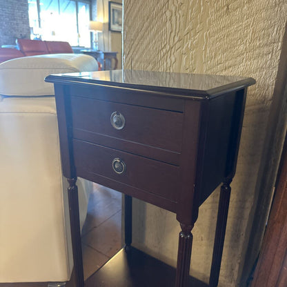 Wooden side table with two drawers in a living room setting