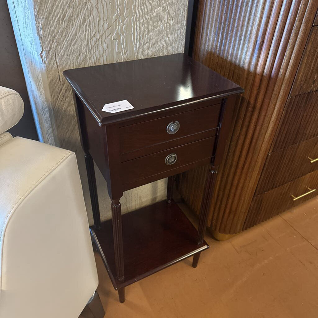 Wooden side table with two drawers in a room setting