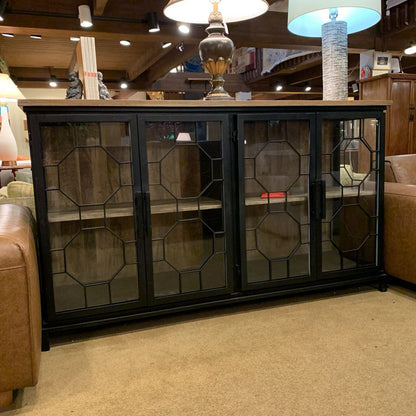 Decorative cabinet with glass doors in a room setting
