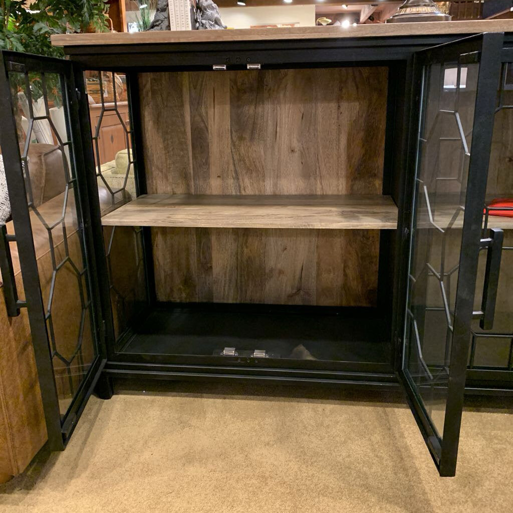 Wooden cabinet with glass doors on a carpeted floor