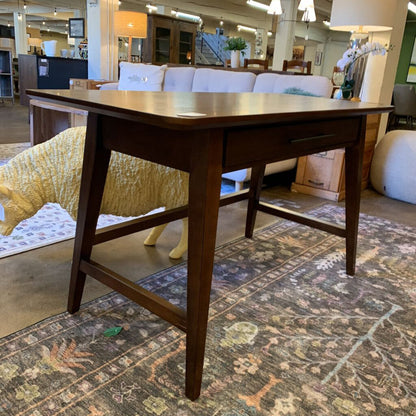Wooden dining table in a room with furniture and decor