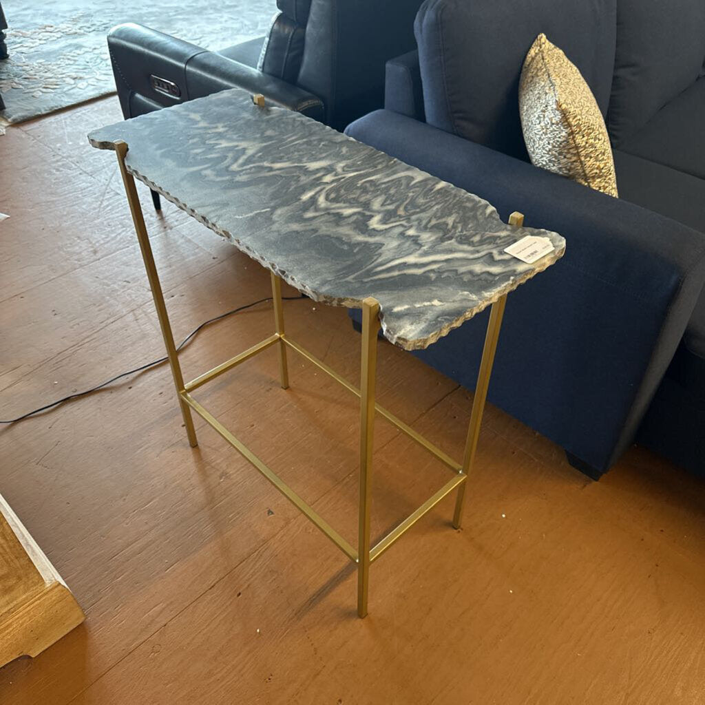 Small marble table with gold legs in a living room setting
