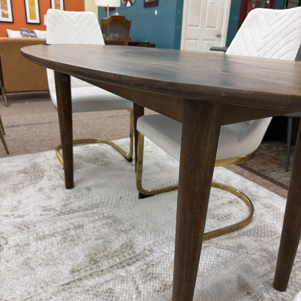 Wooden dining table with white chairs in a room setting