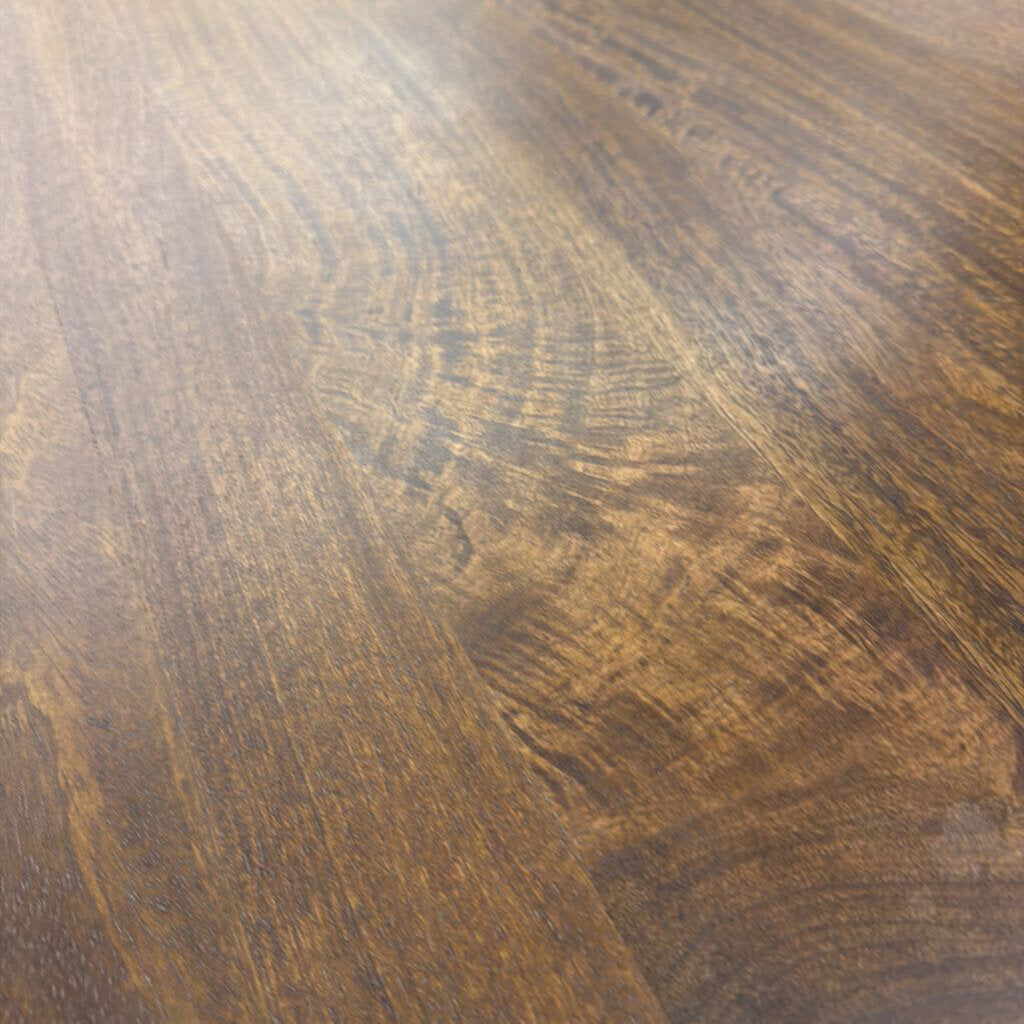 Close-up of a wooden surface with a dark brown finish