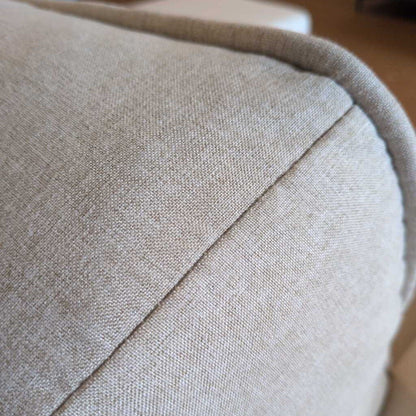 Close-up of a beige fabric surface with a subtle pattern