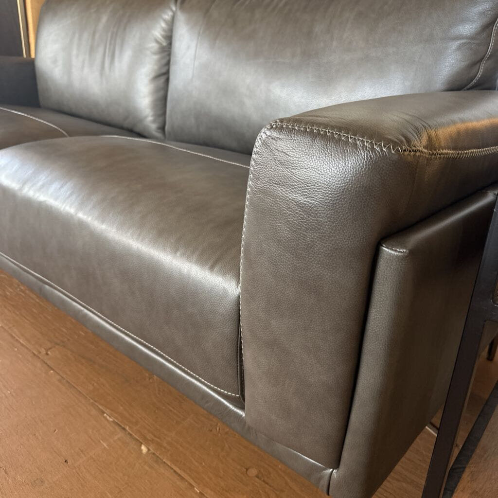 Brown leather sofa on a wooden floor