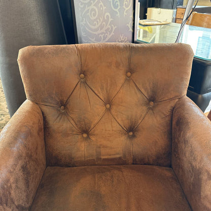 Brown armchair with tufted backrest in a room setting
