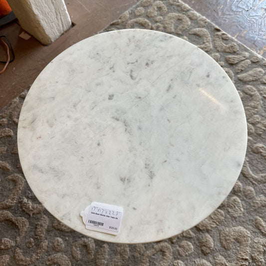 Round marble-like object with a label on a textured surface