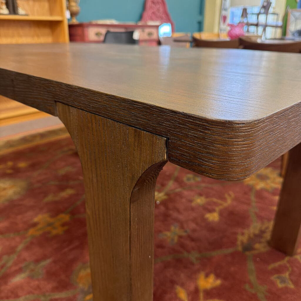 Close-up of a wooden table with a blurred background