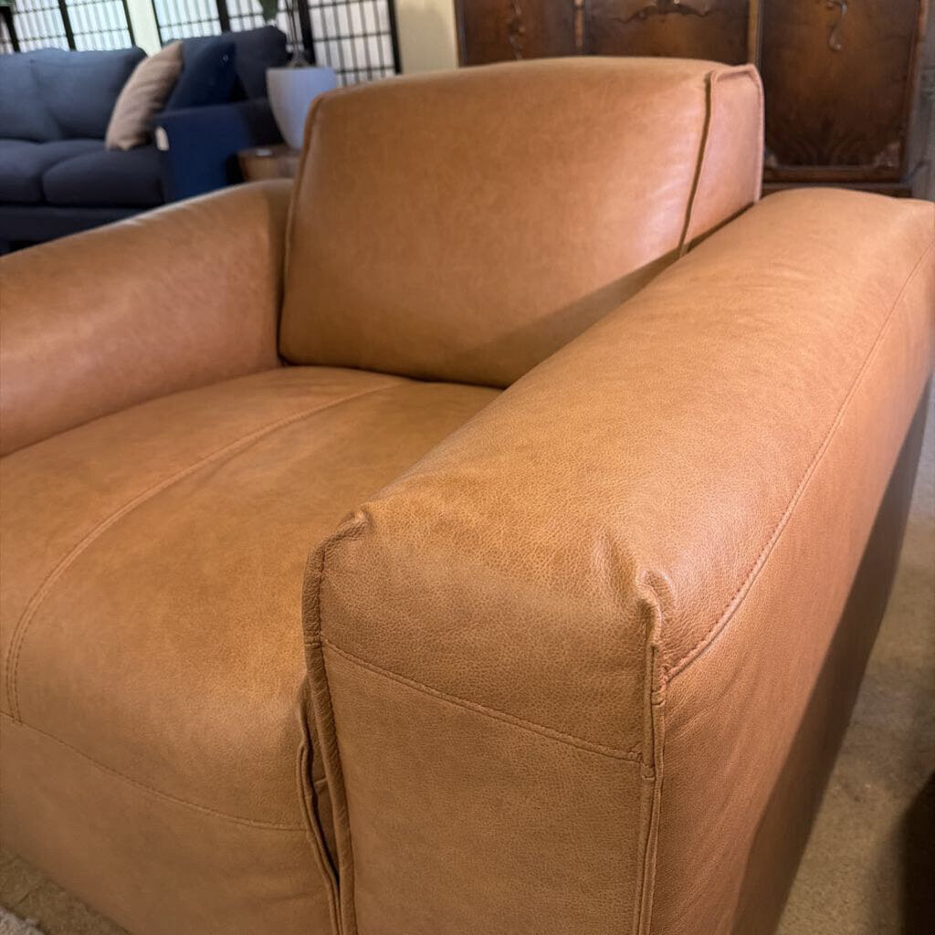 Brown leather sofa in a room with other furniture.