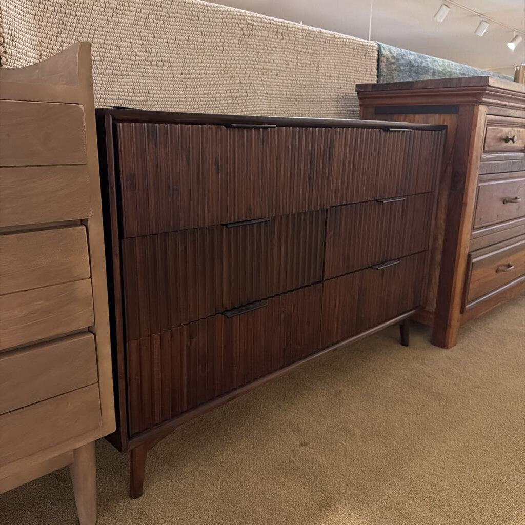 Wooden dresser with multiple drawers in a store setting