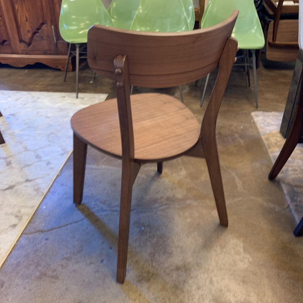 Wooden chair with a green table in the background