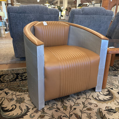 Brown chair with metal accents in a showroom setting